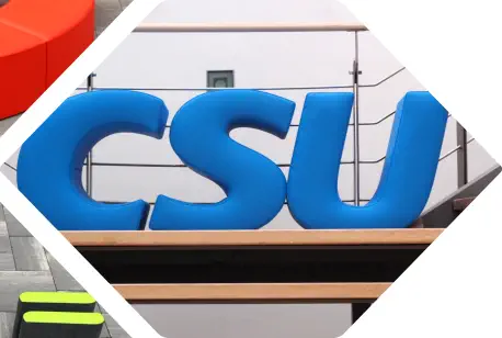 aufrecht stehende blaue CSU Sitzbuchstaben stehen auf einer Treppe
